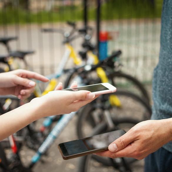 Płatność telefonem za dodatkową usługę w agroturystyce przy stojaku z rowerami